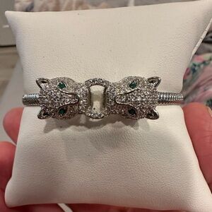 NWOT rhinestone silvertone lion head cuff ribbed bracelet w/ green eye accents.